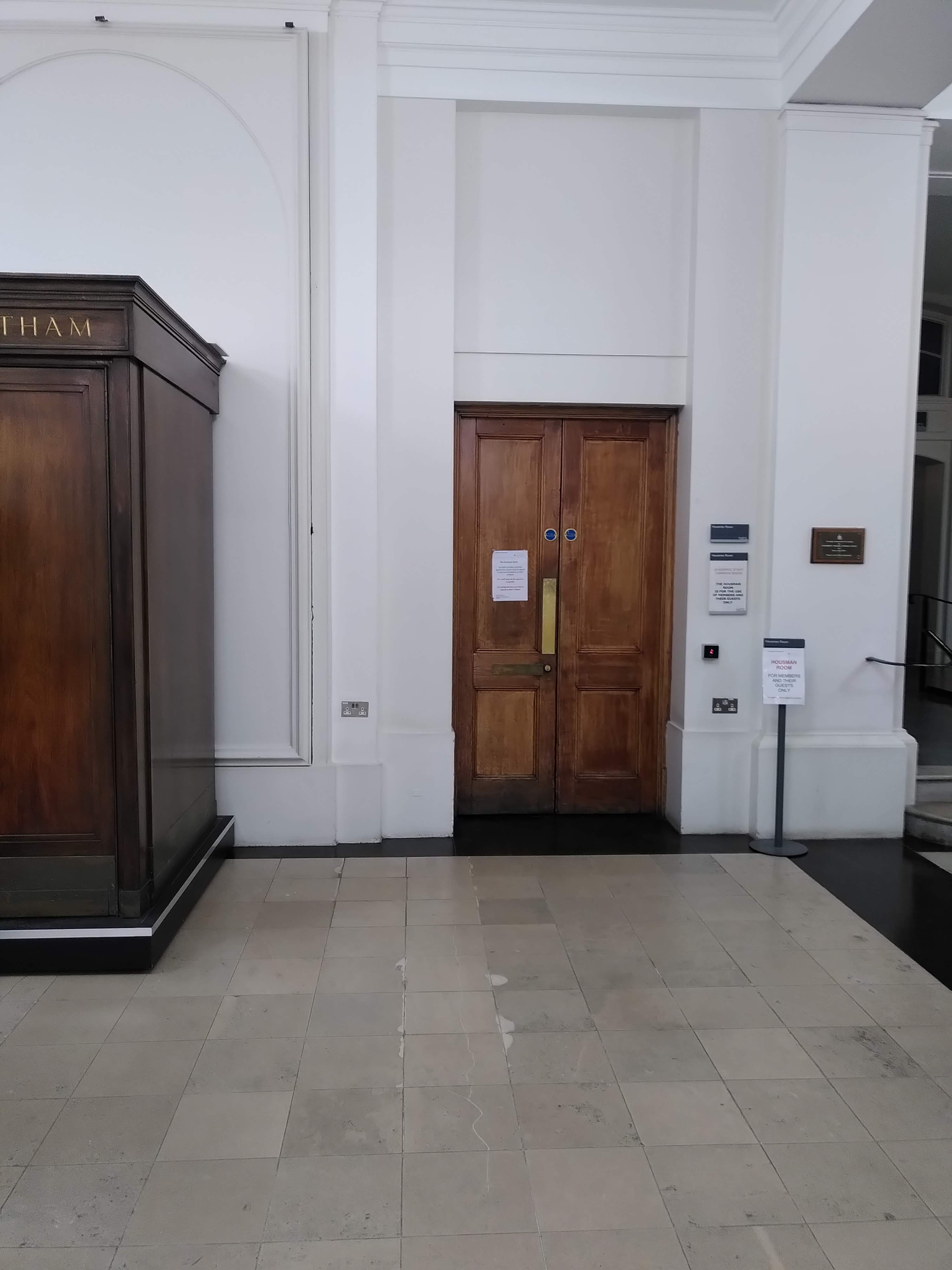 An old brown door is seen in the distance.